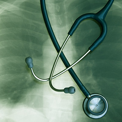 Stethoscope laying on top of x-ray
