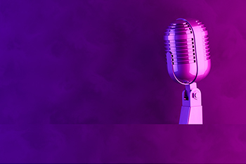 A microphone bathed in purple light