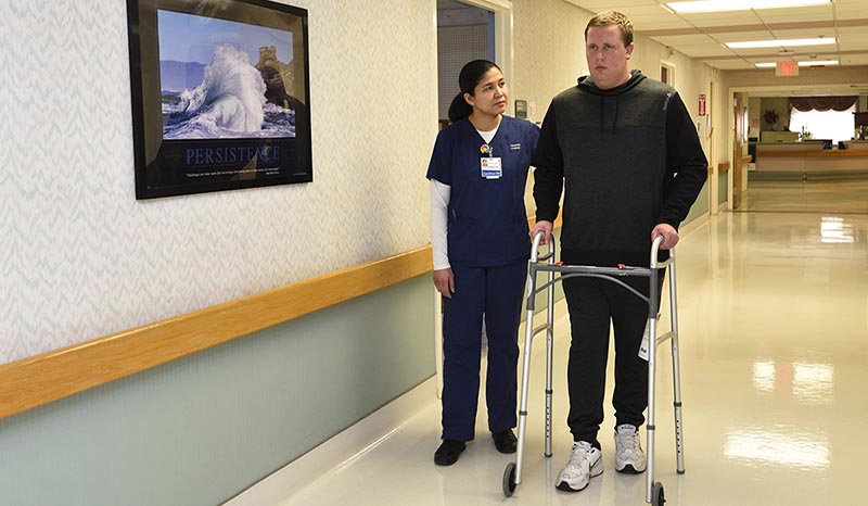 A nurse helping a patient with walking